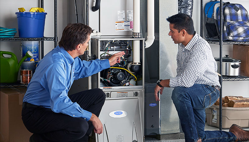 HVAC technician evaluating a furnace for repair or replacement in Tempe