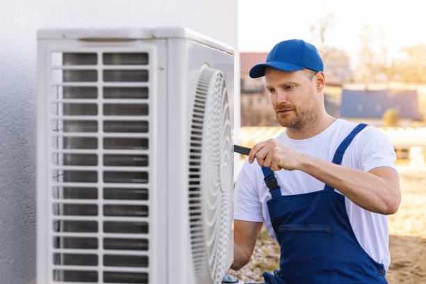 HVAC technician servicing an outdoor air conditioning unit in Tempe