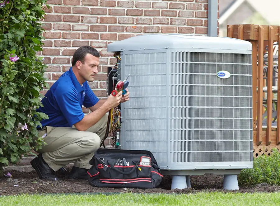 HVAC technician inspecting an outdoor air conditioning unit in Tempe