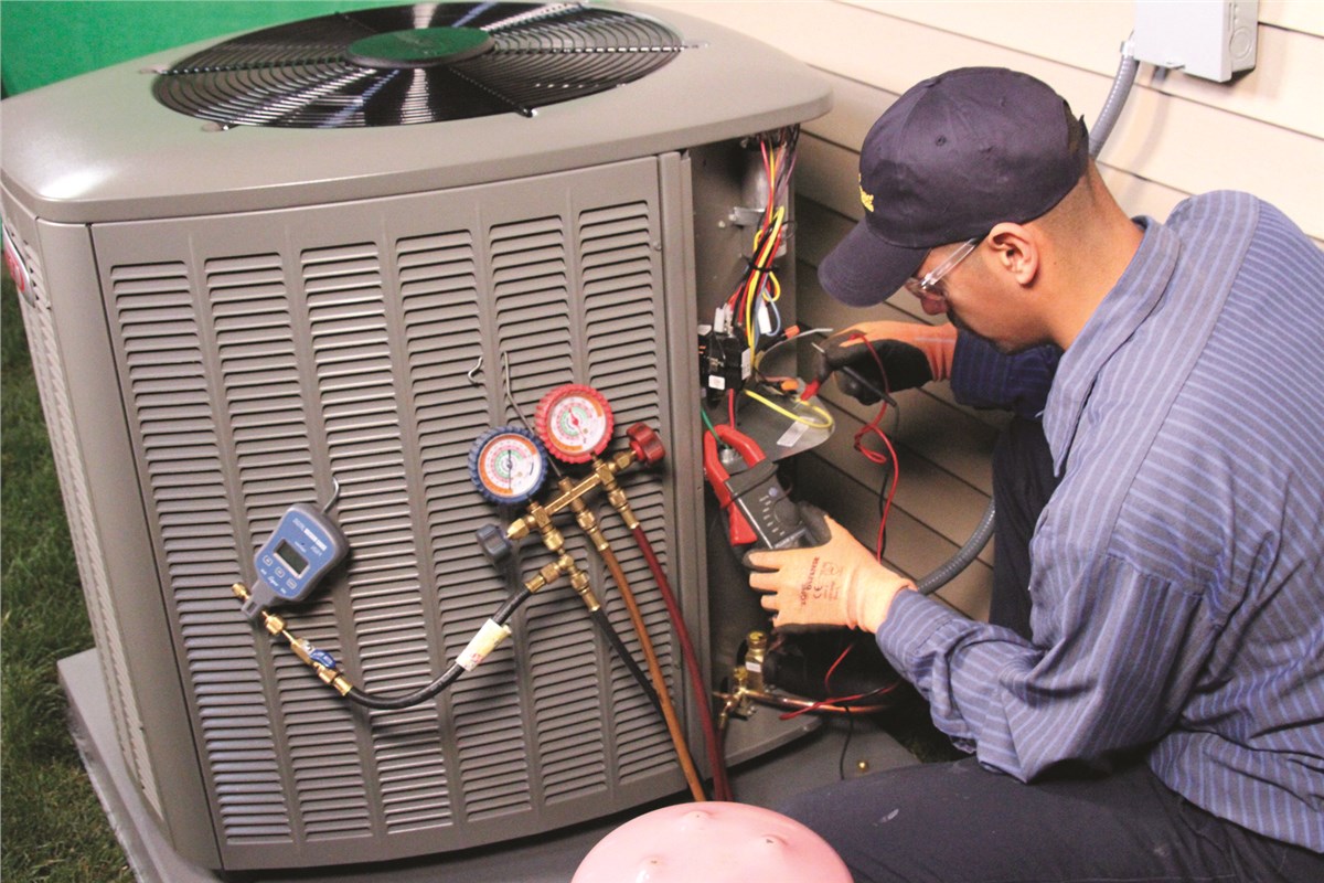 HVAC technician testing an outdoor air conditioning unit in Tempe